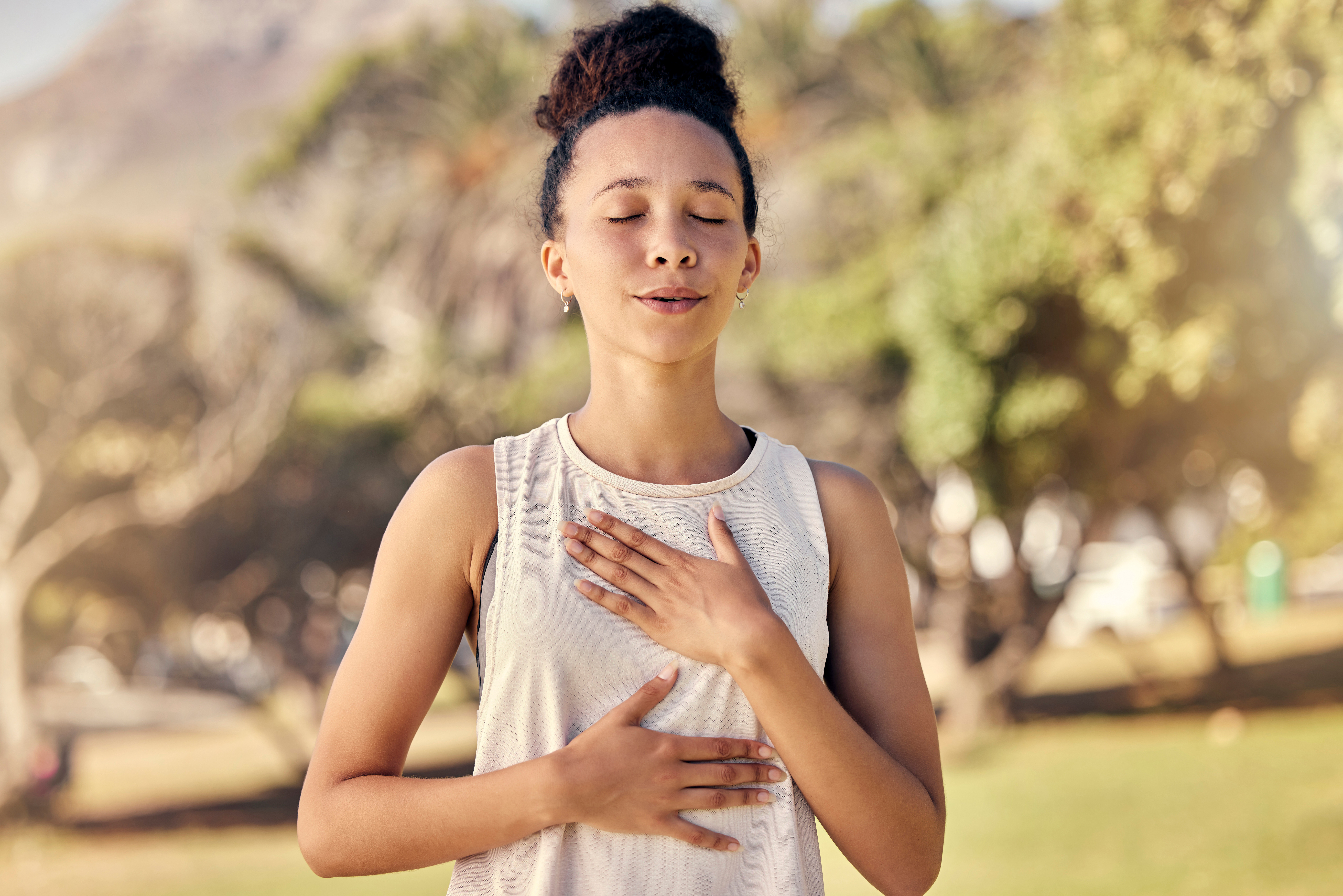 Woman practicing breath awareness with hands over chest